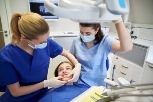 young girl learning about tooth extraction and orthodontics